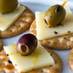 Savory Delight: Creamy Havarti and Olives on Crackers